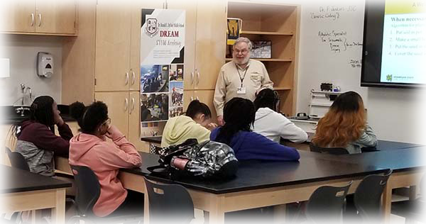 Dr. Bob Brown works with students at the Ronald E. McNair Middle School